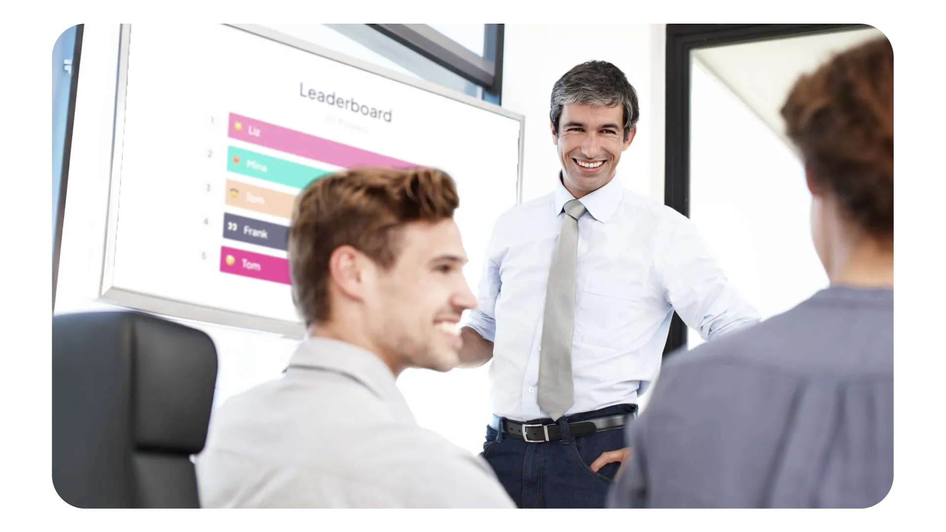 Person som presenterer foran en gruppe fagfolk med en AhaSlides-ledertavle