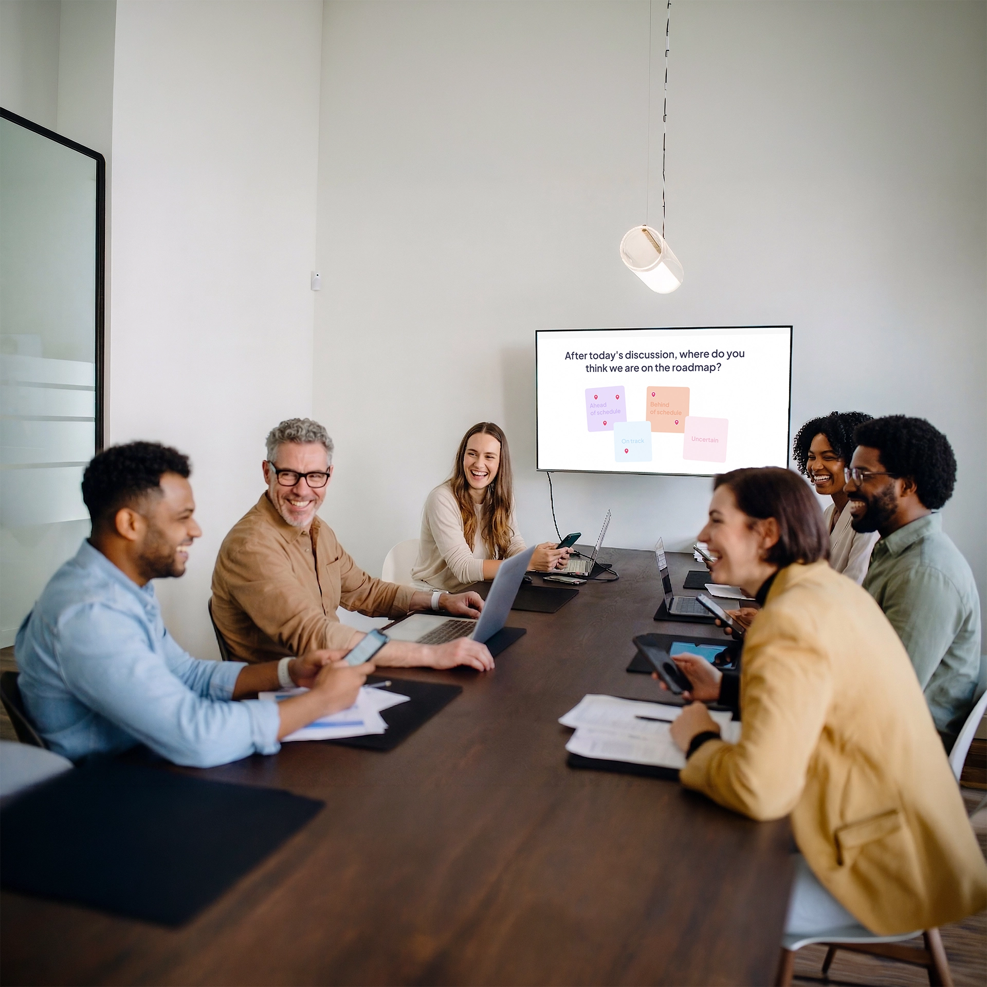A meeting of 5 people, behind them is the screen showing AhaSlides' pin on image activity