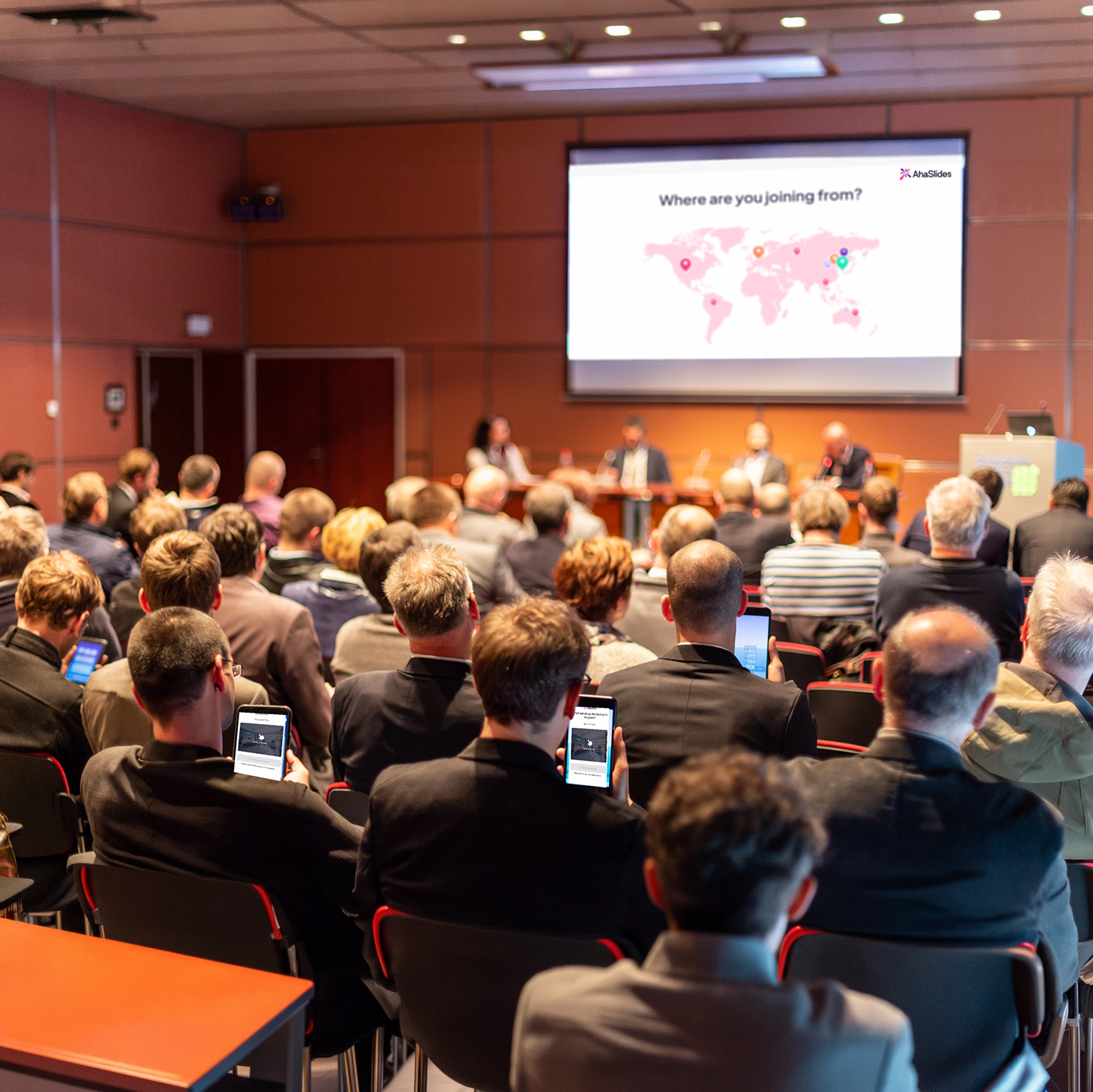 A conference with speakers using AhaSlides' pin image activity to ice break