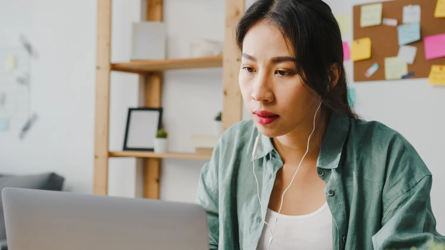 A woman attends an online meeting