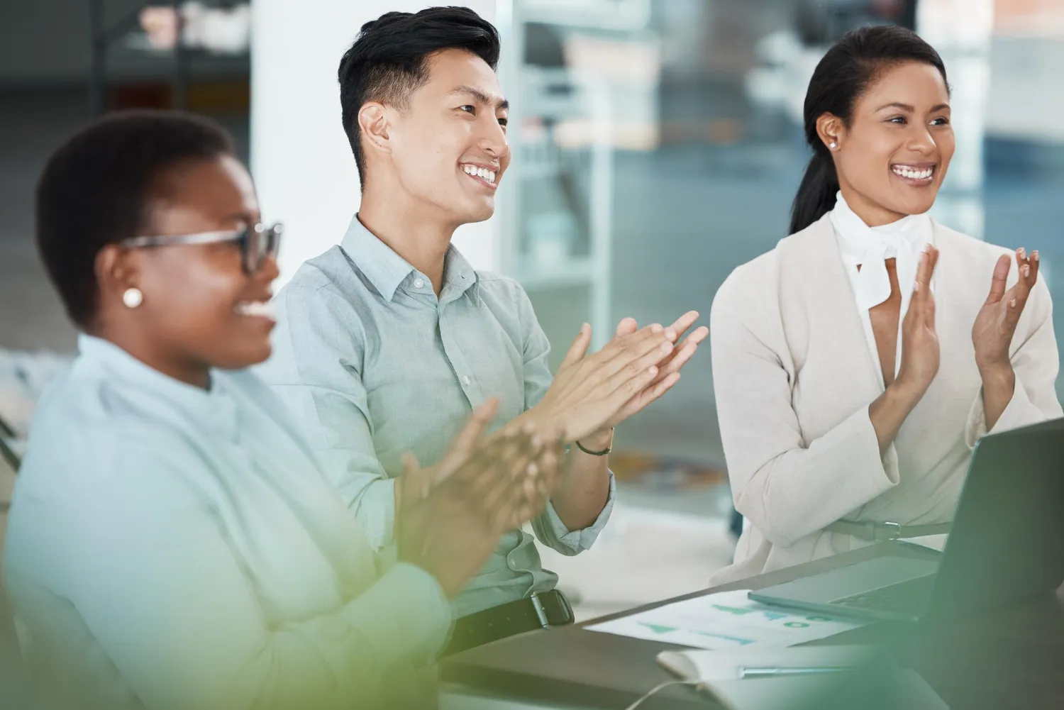 People smiling and clapping their hands during a training