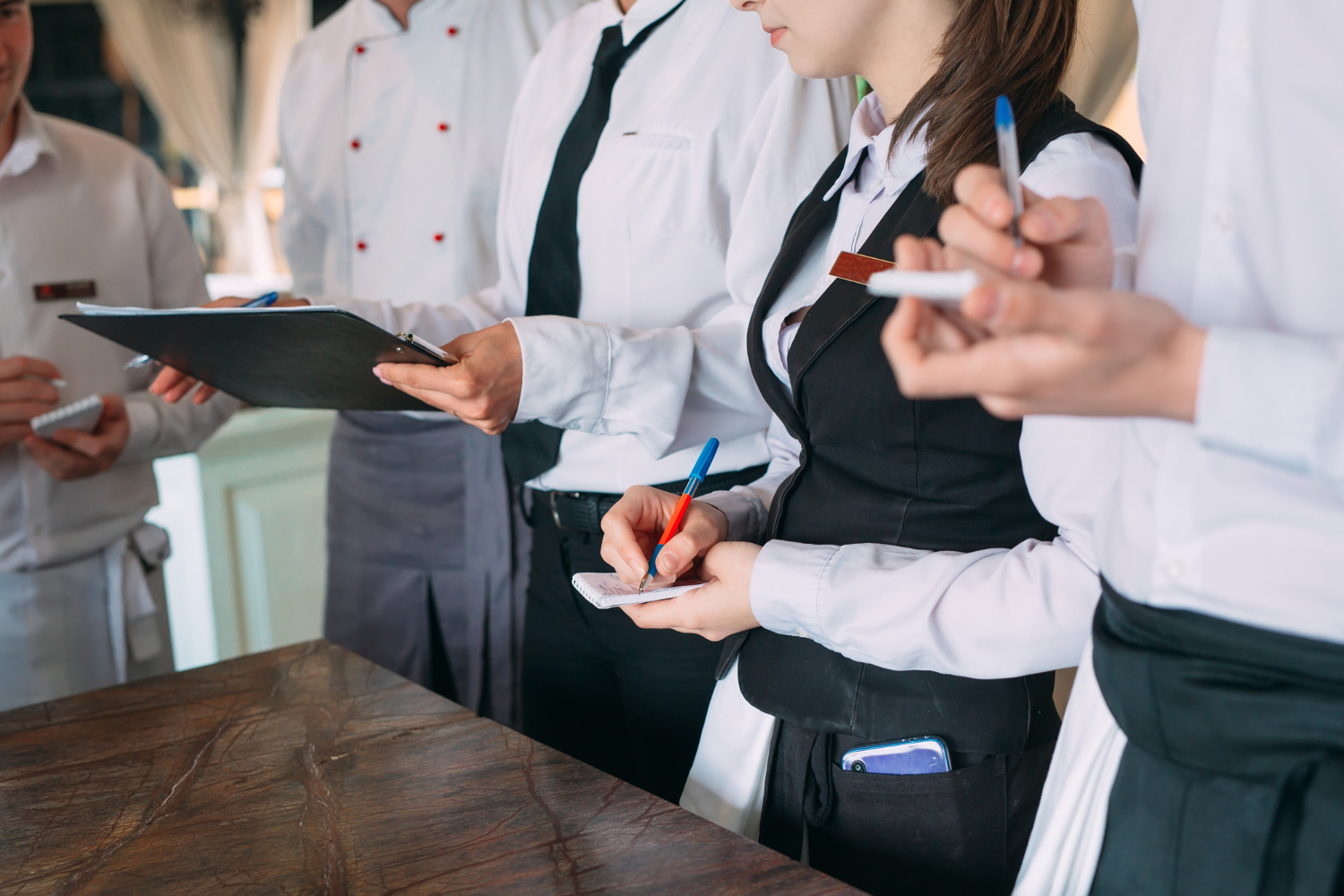 Hospitality staffs taking notes
