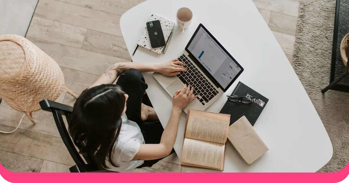 Person preparing a PowerPoint presentation with speaker notes on a laptop at a clean desk