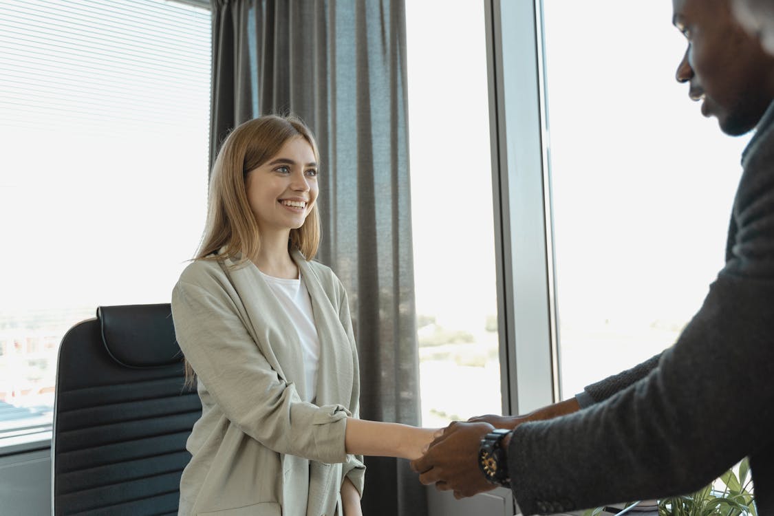 Two professionals having a positive one-on-one conversation in a bright office