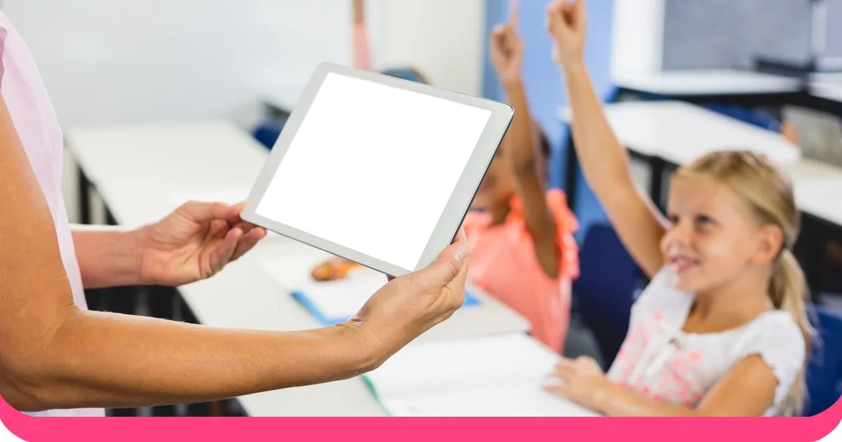 Teacher using a tablet with engaged students in a modern classroom