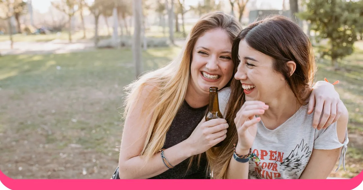Two best friends laughing together outdoors