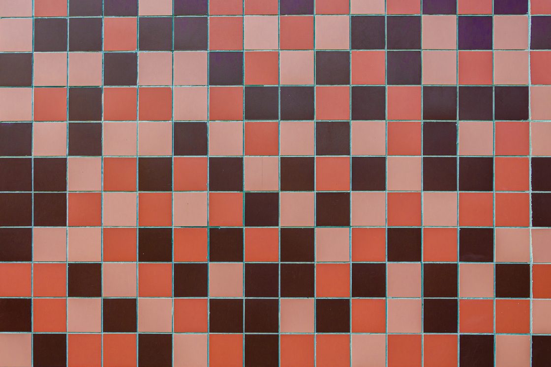 A grid of small pink, red and dark brown square tiles, the kind of pattern a hidden-picture game covers an image with