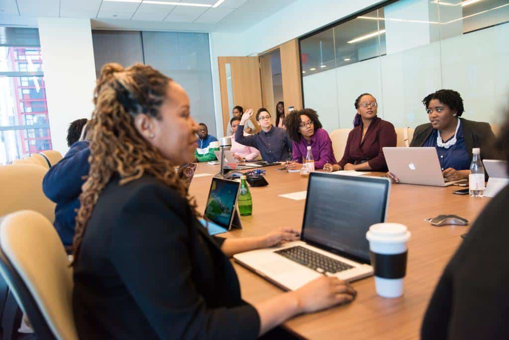 People mixing virtual facilitation with an in-person meeting.