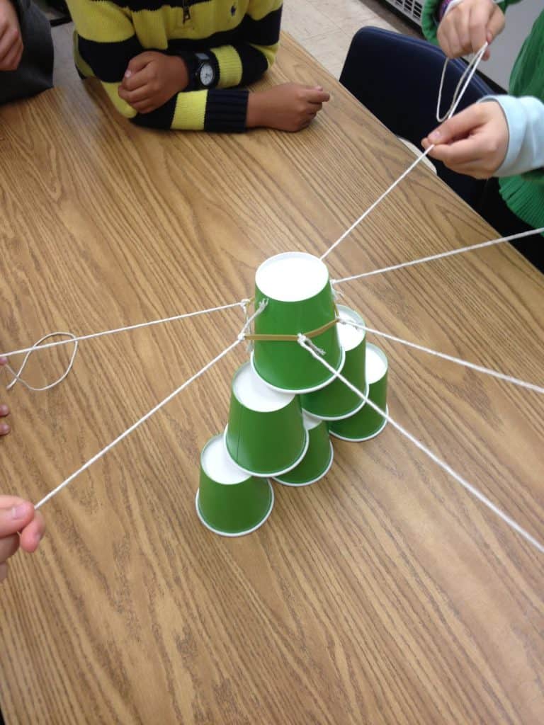 Students playing team cup stack together