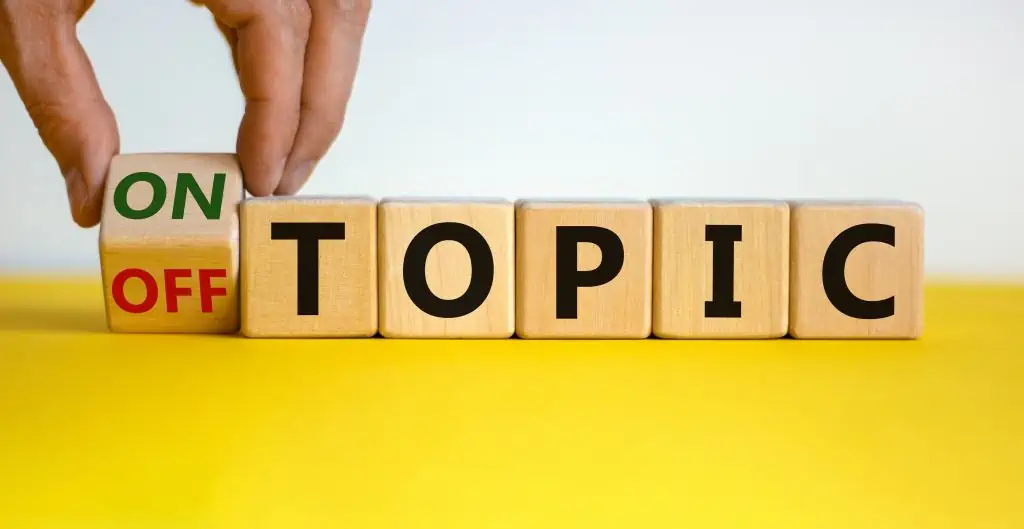 Wooden blocks spelling the word topic with a on/off block at the start. Use a 5-minute presentation topic list to choose the right topic for your short presentation