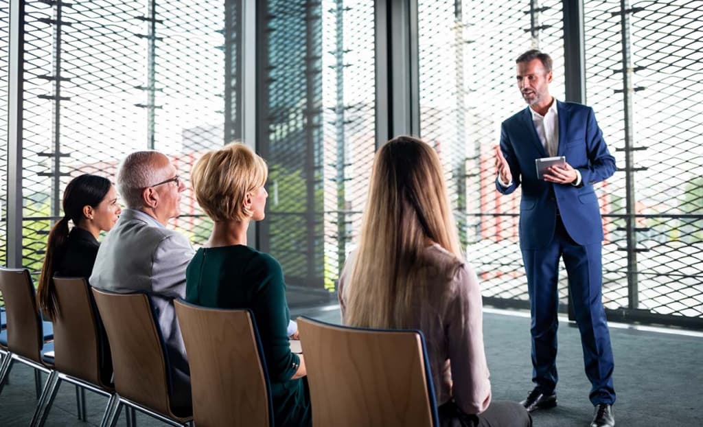 A man getting over his fear of public speaking by practicing with friends