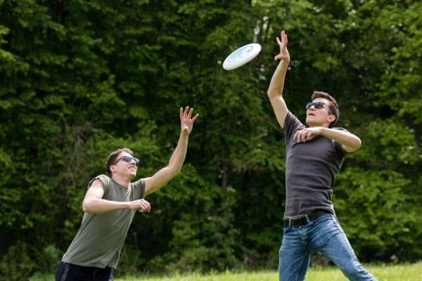 Adult Men Jumping High Catching Frisbee 600x400 