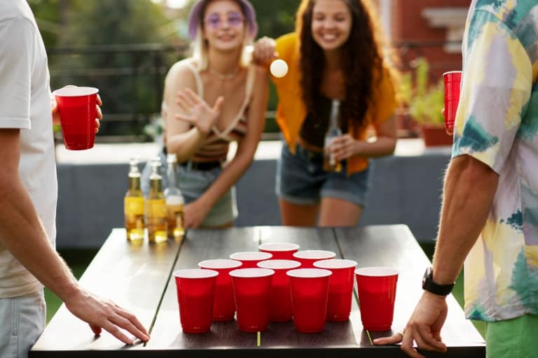 Front View Women Playing Beer Pong 1 768x512 