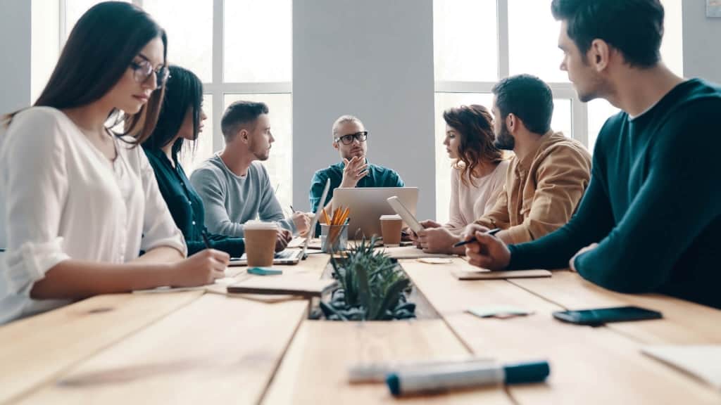 people discussing in a staff meeting