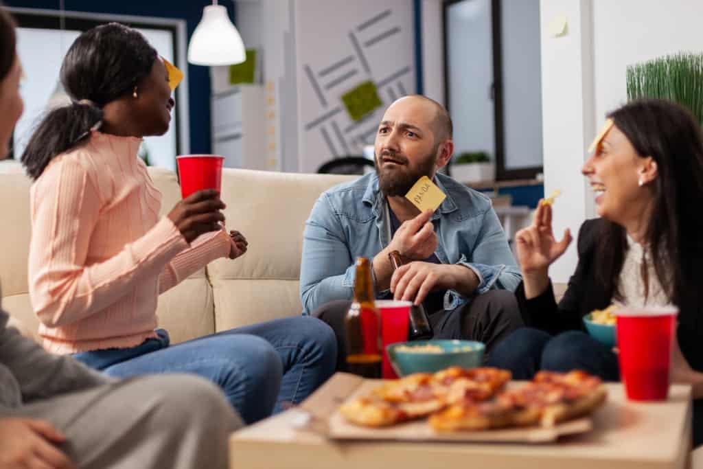 guests playing an icebreaker game -dinner party games for adults