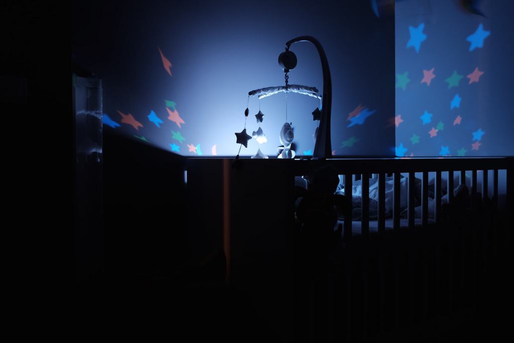 cribs in dark rooms with stars