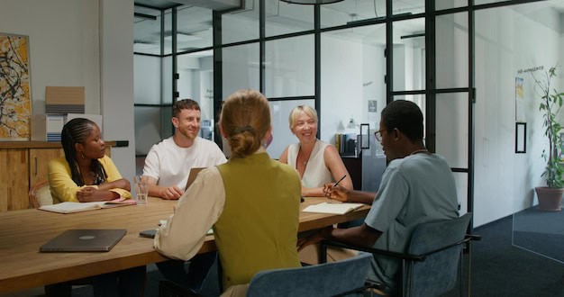 Diverse team collaborating during year-end review meeting in modern office setting
