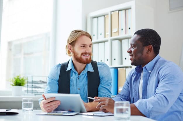 Professional manager and employee having performance review discussion in office