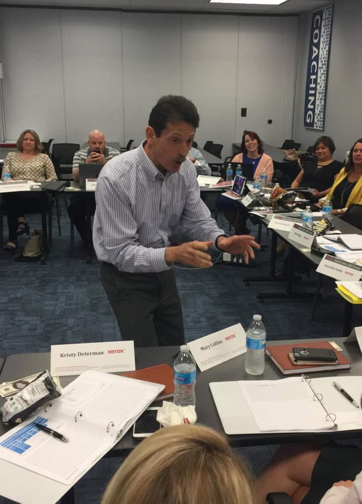 Dave Choura explaining terms in front of a group of trainees